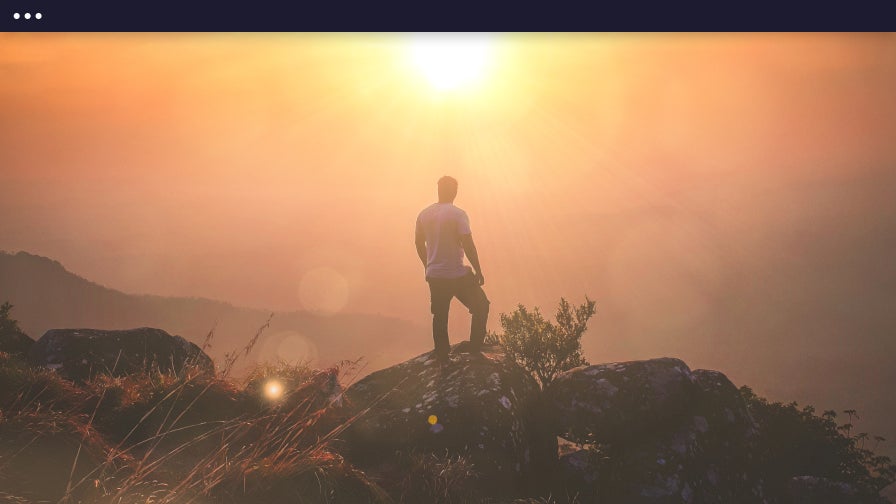 lens flare effect on photo of man looking over mountains