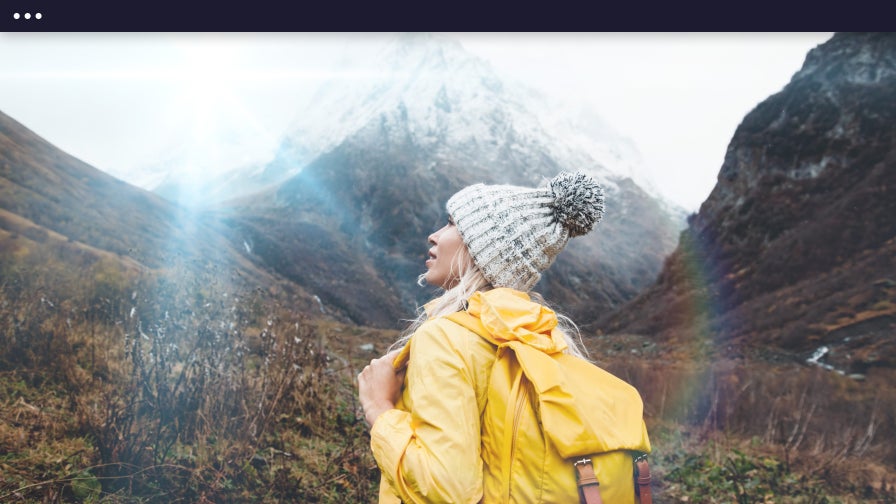 lens flare effect on photo of woman hiking in mountains