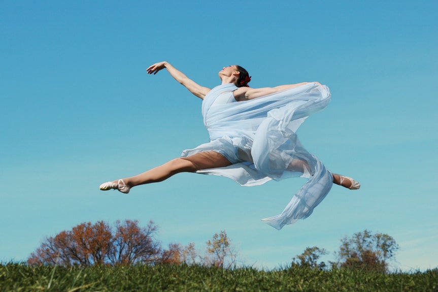 woman leaping with edited sky background