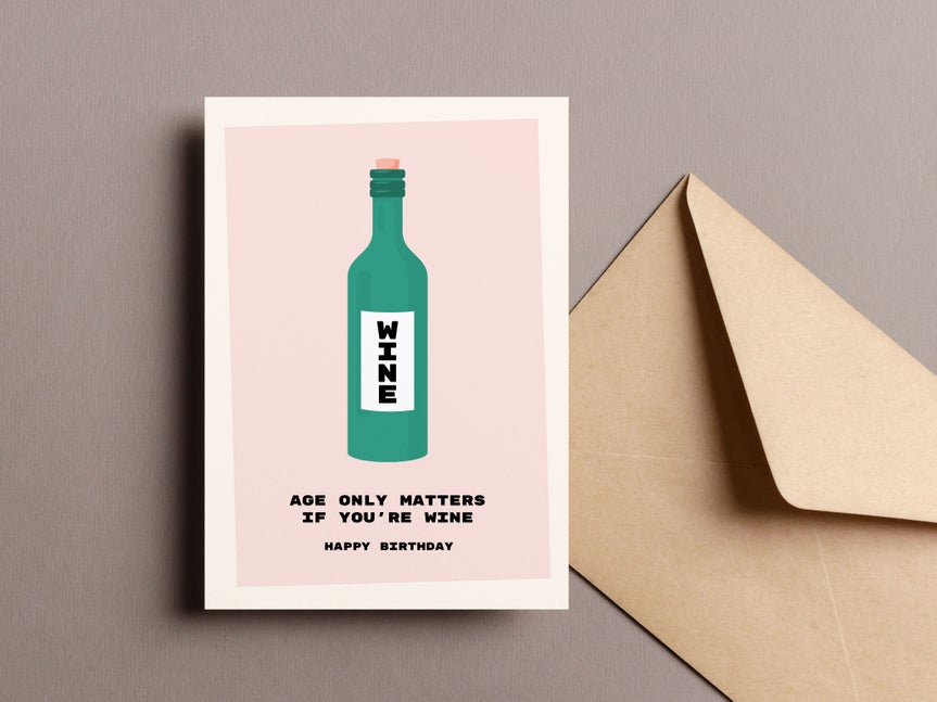 Printed birthday card with a wine bottle design and beige envelope on a gray background