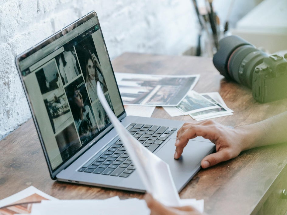 Photographer viewing photos on laptop