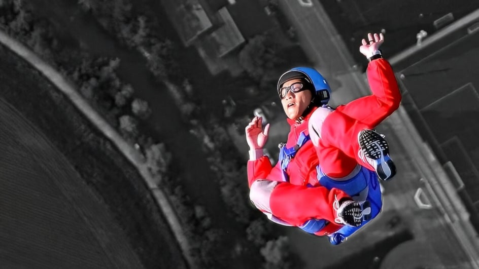 Black and white photo of skydiver with subject colorized to show depth of field